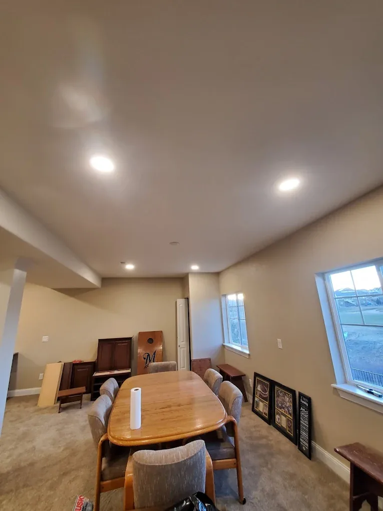 Finished basement room with evenly spaced recessed ceiling lights