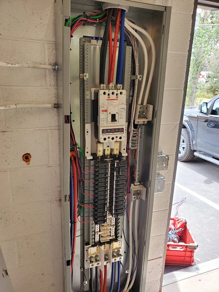 Open commercial electrical panel with neatly dressed circuit conductors
