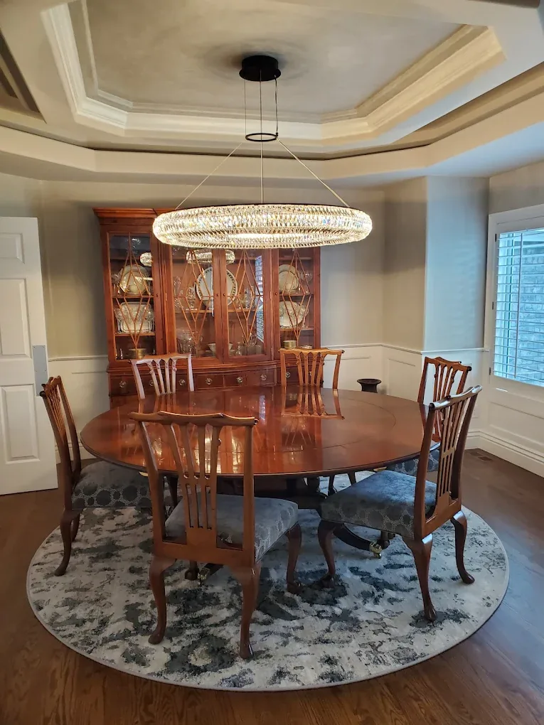 Crystal ring chandelier hung in a coffered dining room ceiling