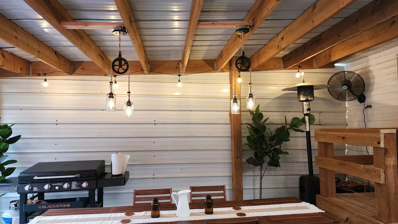 Custom pendant and string lighting installed on a covered patio by Bolt Electrical