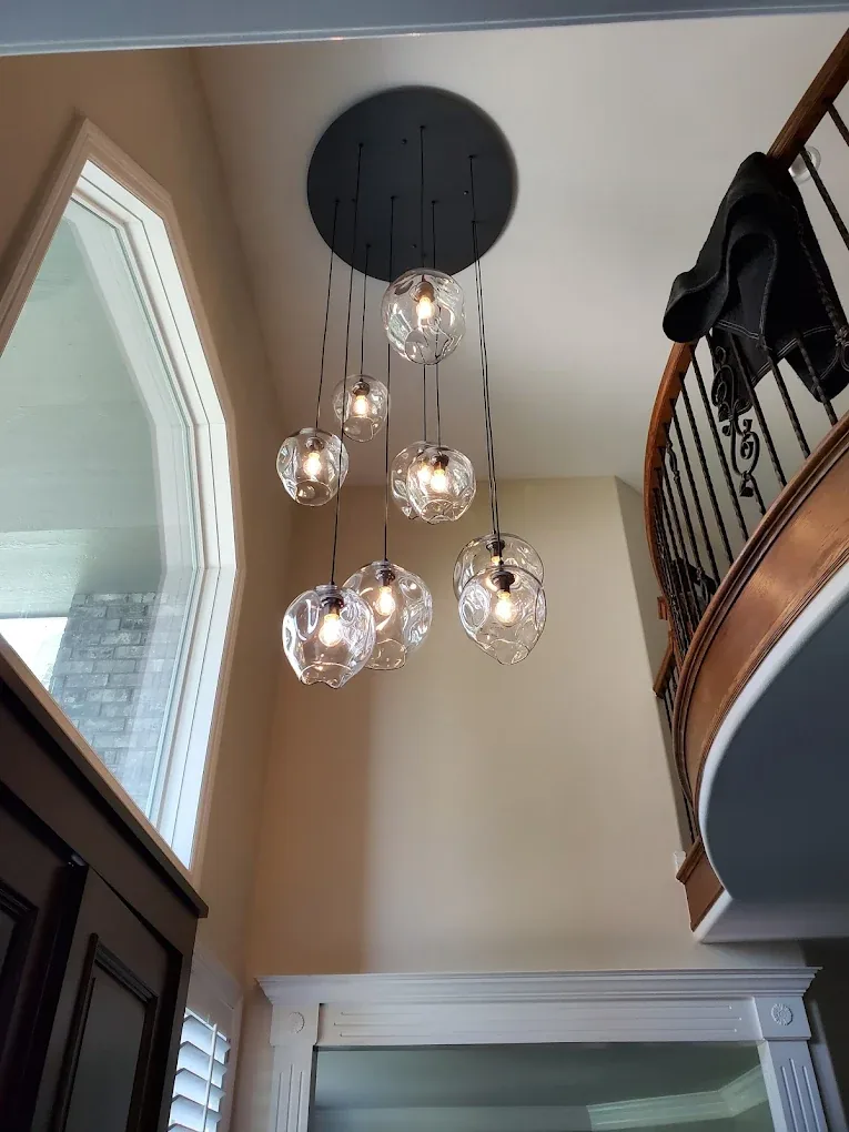 Cluster of hand-blown glass pendants hung in a two-story stairwell